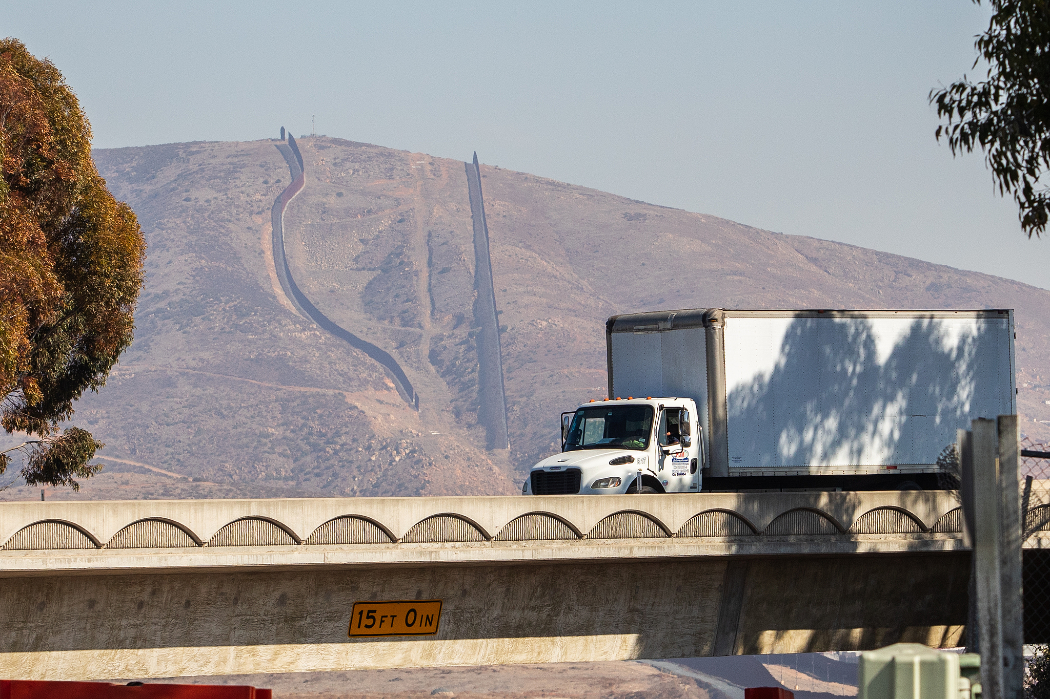 A truck drives into the United States at the US-Mexico border fence seen on the background at the Otay Mesa Port of Entry, February 1, 2025. /CFP
